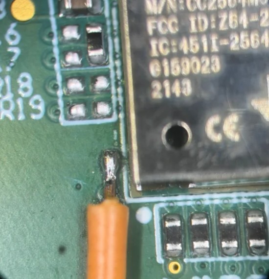 Microscope view of a debug trace wire soldered to a Bluetooth modem