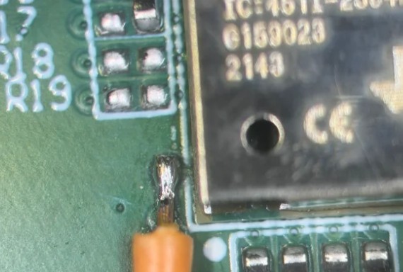 Microscope view of a debug trace wire soldered to a Bluetooth modem